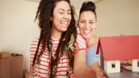 Smiling-lesbian-couple-unpacking-cardboard-box