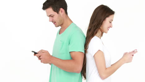 Couple-standing-back-to-back-and-texting-