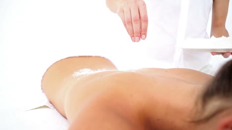 Pretty-woman-enjoying-a-salt-scrub-massage