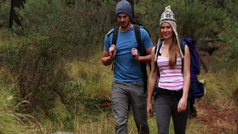 Happy-couple-hiking-and-taking-a-break