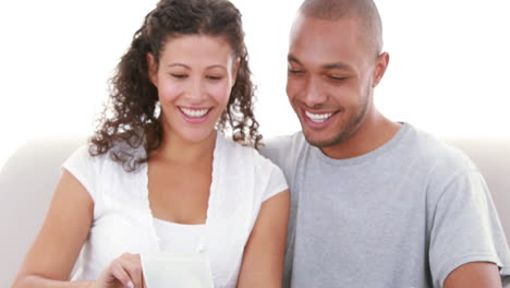 Relaxed-couple-on-the-sofa-looking-at-the-ultrasound