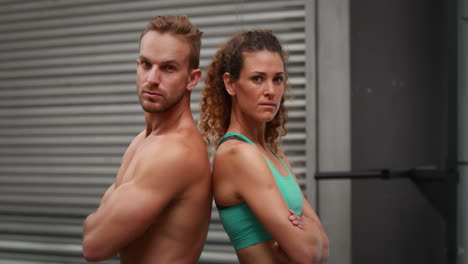 Fit-couple-posing-at-crossfit-gym