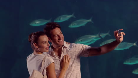 -Happy-couple-taking-a-selfie-at-the-aquarium