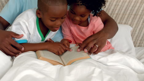 Father-and-children-reading-in-bed