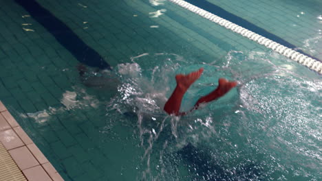 Cropped-view-of-swimmer-diving-into-pool