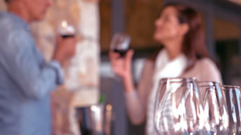 Smiling-couple-toasting-with-red-wine-in-slow-motion