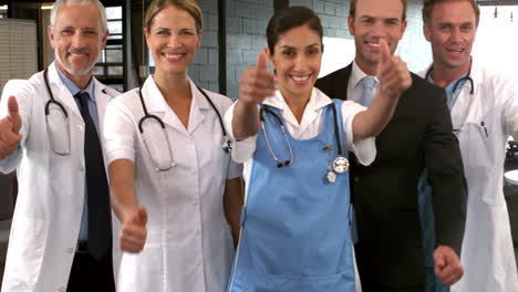 Smiling-medical-team-with-thumbs-up