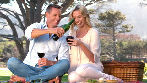 Smiling-couple-enjoying-wine-together-in-slow-motion