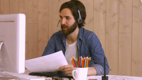Hipster-worker-using-video-chat-at-desk