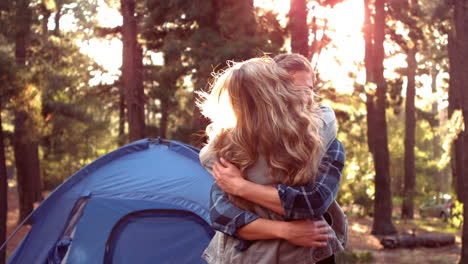 Couple-hugging-beside-their-tent