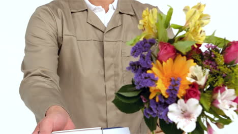 Postman-holding-flowers-and-handing-document