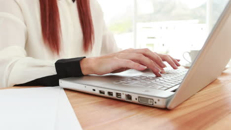 Red-haired-hipster-using-a-laptop