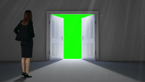 Door-opening-to-green-screen-watched-by-businesswoman