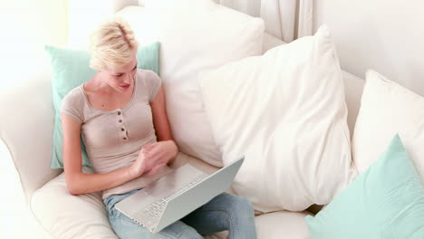 Blonde-using-video-chat-on-her-laptop