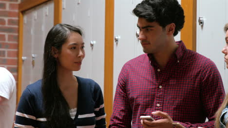 Students-on-their-smartphone-leaning-on-lockers