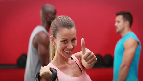 Woman-holding-kettlebell-in-crossfit-gym