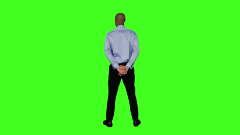 Businessman-standing-with-hands-behind-back