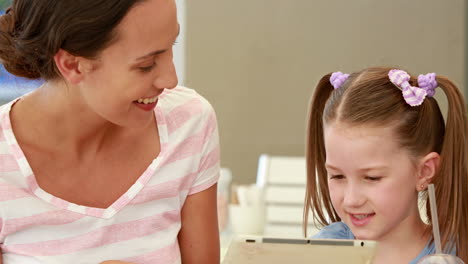 Mother-and-daughter-using-tablet-computer-together