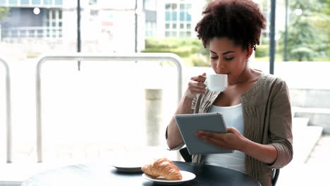 College-student-using-tablet-at-campus-cafe