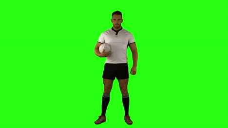 Serious-rugby-player-holding-ball-