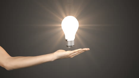Hand-presenting-light-bulb