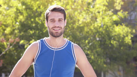 Happy-jogger-smiling-at-camera-with-thumbs-up-