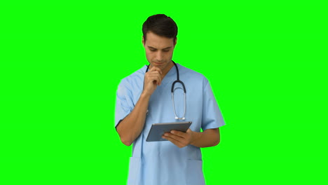 Young-doctor-standing-with-clipboard