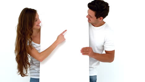 Happy-couple-holding-white-sheet