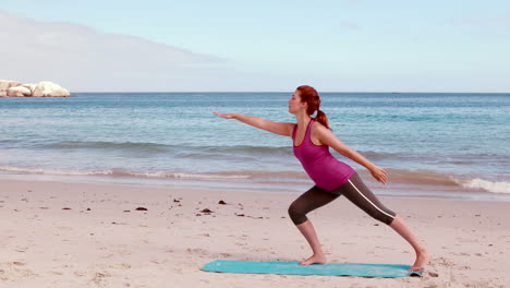 Woman-doing-yoga-on-the-beach