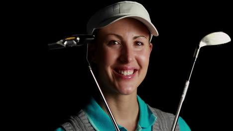 Smiling-golf-player-holding-golf-sticks