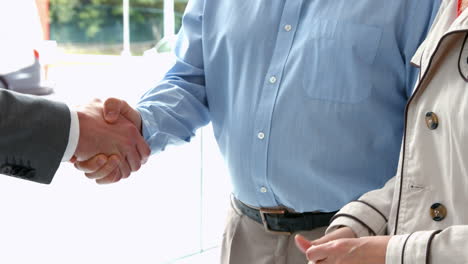 Couple-taking-keys-from-businessman