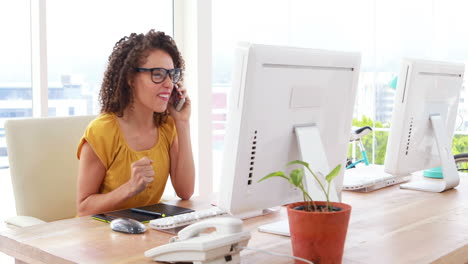 Excited-businesswoman-talking-on-the-phone