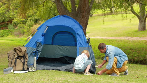 Father-and-son-preparing-their-tent-