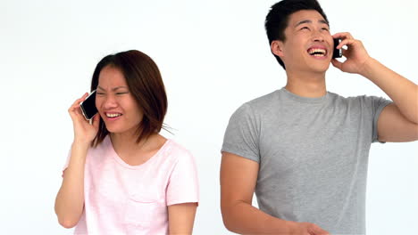 Asian-couple-laughing-on-phone-call