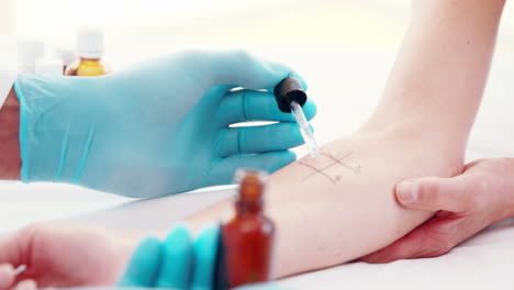 Doctor-doing-skin-prick-test-at-his-patient-