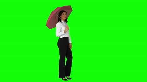 Businesswoman-wearing-umbrella-on-green-screen-