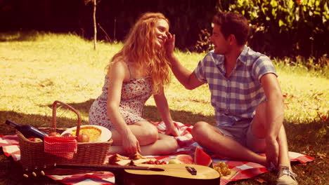 Happy-cute-couple-hugging-during-picnic-