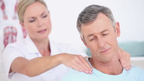 Doctor-massaging-her-patients-shoulders