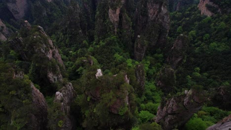 Overhead-aerial-shot-of-impressive-high-cliffs-in-Zhangjiajie-Forest-Park,-China