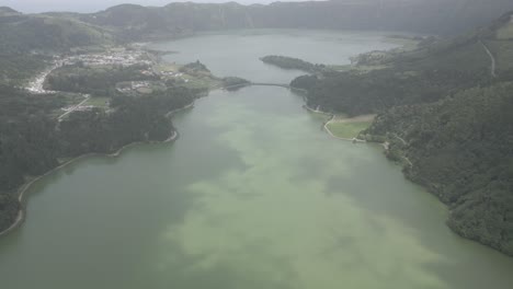 Sete-cidades,-portugal-with-two-lakes-surrounded-by-lush-green-hills-and-villages,-aerial-view