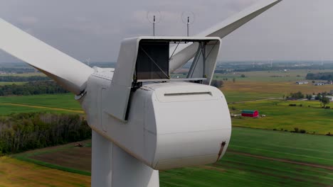 Wind-Turbine-Nacelle-Rear-with-Propeller-Blades,-Aerial-Panning-Shot