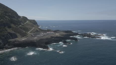 Ponta-da-ferraria-with-rocky-coast-and-blue-ocean-waves,-aerial-view