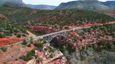 Drone-footage-of-a-beautiful-bridge-crossing-the-red-rocks-in-Sedona,-Arizona