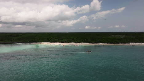 Top-view-of-beach-and-clear-green-water-on-tropical-sea-coast-with-sandy-beach