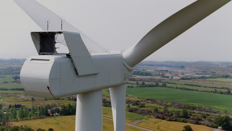 Wind-Turbine-Rear-View-with-Propellers-from-an-Aerial-Drone-Panning,-Close-Up-Shot