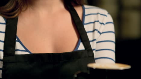 Smiling-barista-holding-coffee