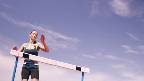 Sportswoman-practicing-hurdle-race