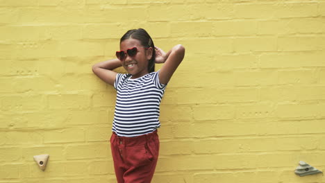 In-a-schoolyard,-a-young-biracial-girl-poses-confidently-with-copy-space