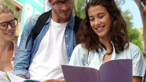 Friends-smiling-while-reading-books