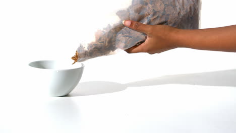 Woman-pouring-cereals-in-a-bowl